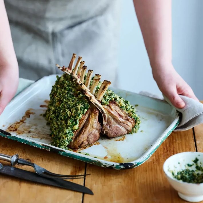 A herb-crusted rack of lamb from Field & Flower on a roasting tray